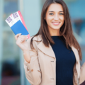 woman holding passport and airline tickets
